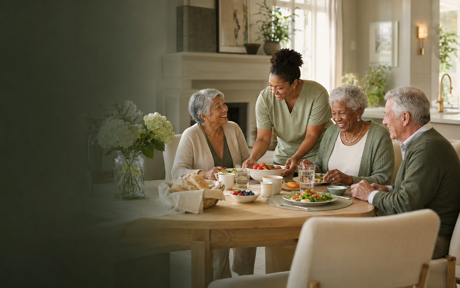 Caregiver and older residents enjoying a meal together